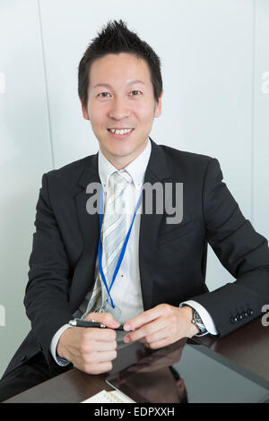 Smiling Businessman Looking at Camera Stock Photo