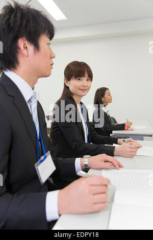 Business People Listening Attentively to Presentation Stock Photo