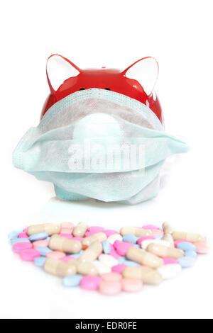 Pink piggy bank wearing a protective face mask. Concept for protection, flu, virus, sickness. Stock Photo