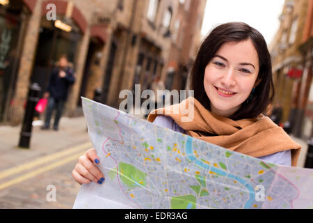 young woman holding a map. Stock Photo