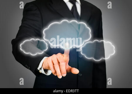 Businessman clicking on thought bubbles Stock Photo