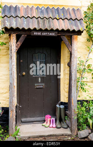 Wellington boots at front door of quaint traditional cottage in Bossington in Exmoor, Somerset, United Kingdom Stock Photo