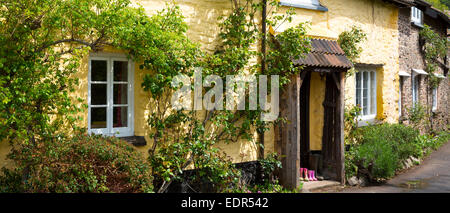 Wellington boots at front door of quaint traditional cottage in Bossington in Exmoor, Somerset, United Kingdom Stock Photo