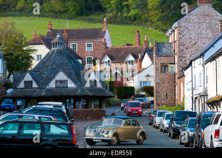 Motoring in a Vintage Riley 3 litre saloon car through the old medieval town of Dunster, in Somerset, UK Stock Photo