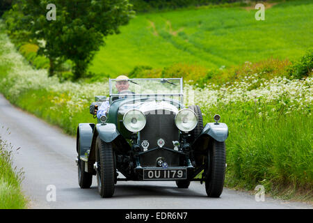 Vintage Bentley four and a half litres luxury car built in 1929 being driven on touring holiday in The Cotswolds in Oxfordshire Stock Photo