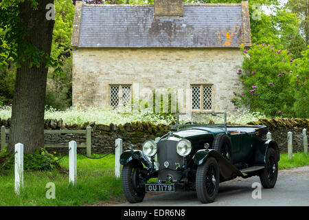 Vintage Bentley four and a half litres luxury car built in 1929 being driven on touring holiday in The Cotswolds in Oxfordshire Stock Photo