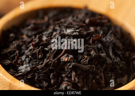 Dry Black Loose Leaf Tea in a Bowl Stock Photo