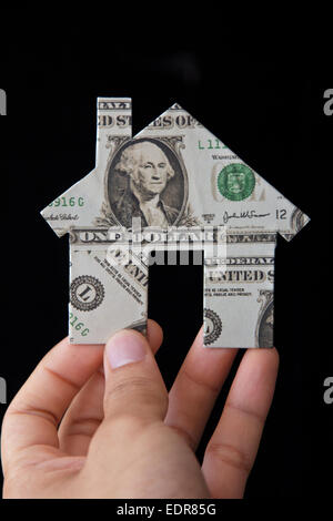 Hand holding banknote house icon Stock Photo - Alamy