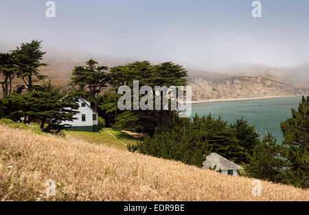 Residence surrounded by Monterey cypress trees above Historic Lifeboat Station, Chimney Rock Trail Point Reyes National Seashore Stock Photo
