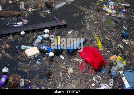 Litter floating in canal in Walsall town centre, West Midlands, England, UK Stock Photo