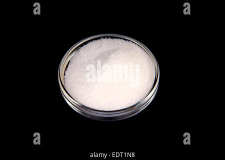 Glass bowl with sugar on a black background Stock Photo