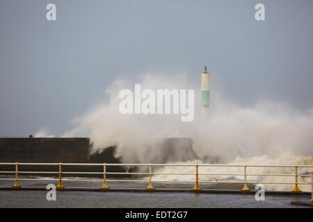 Aberystwyth, Wales, UK. 9 January 2015. Huge waves break over the harbour wall and it's lighthouse during stormy weather Credit:  Alan Hale/Alamy Live News Stock Photo