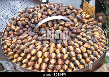 Grilled chestnuts for sale in a market stall Stock Photo