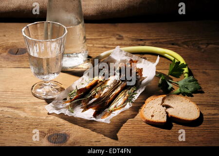 Still Life, glass of vodka with dried capelin and bread, close up Stock Photo