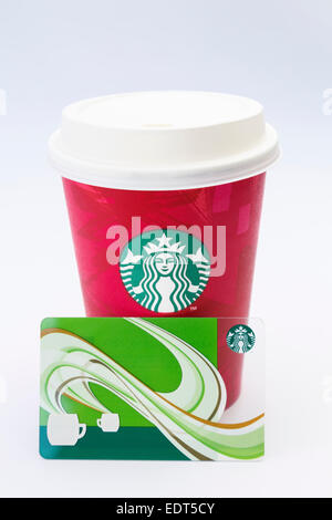 Starbucks disposable take-away paper coffee cup in festive red with plastic drink-through lid and loyalty points card. UK Stock Photo