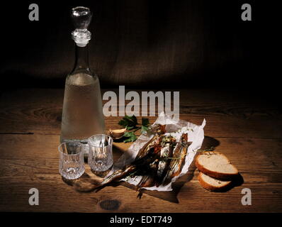 Two glass for vodka with dried capelin and bread, horizontal Stock Photo