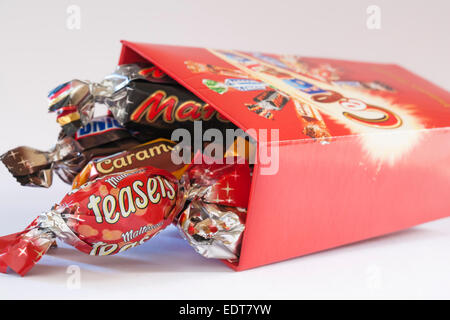 opened box of Celebrations chocolates with contents spilled spilt set on white background Stock Photo