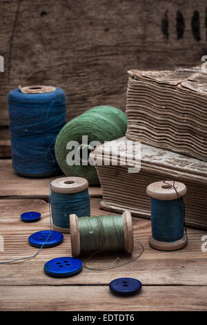 spool sewing thread and buttons in vintage style Stock Photo