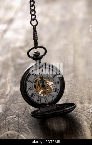 pocket watch over grunge wooden table, close up Stock Photo