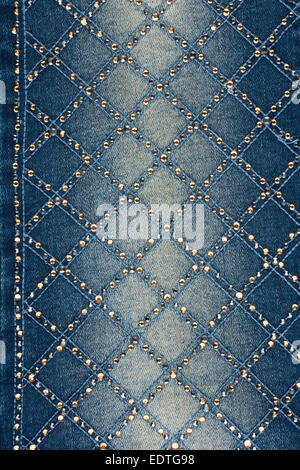 Light-blue denim with yellow and silver rhinestones, background Stock Photo