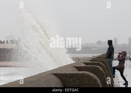 New Brighton, Merseyside, UK. 9th January, 2015.  People watch as huge waves crash into New Brighton promenade in Merseyside Credit:  Adam Vaughan/Alamy Live News Stock Photo