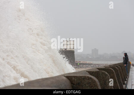 New Brighton, Merseyside, UK. 9th January, 2015.  People watch as huge waves crash into New Brighton promenade in Merseyside Credit:  Adam Vaughan/Alamy Live News Stock Photo