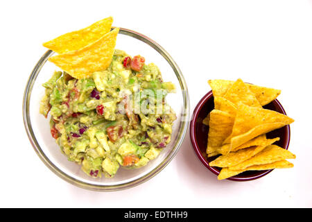 Guacamole and nachos on a white background seen from above Stock Photo