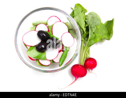 Salad radishes in bowl on white background from above Stock Photo