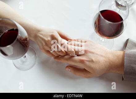 Hands of just married couple  tenderly holding each other, wearing wedding rings Stock Photo