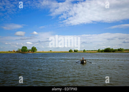 Old woman in rowboat, Danube delta, Romania, Europa Stock Photo