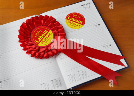 Vote Labour sticker and rosette on a diary on General Election Day, May 7th. 2015. Election concept. Stock Photo