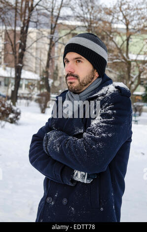 Young man freezing outdoors Stock Photo