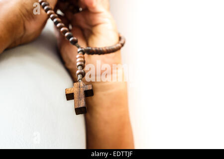 human pray to god with wood rosary Stock Photo