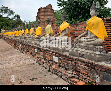 TH00256-00...THAILAND  - A row of Buddhas with surround the main chedi at Wat Chai Mongko in Ayutthaya. Stock Photo