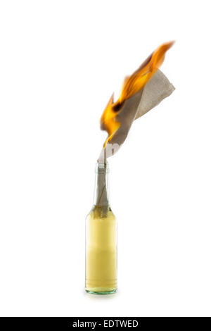 Glass bottle filled with gasoline, a so called Molotov Cocktail, with burning fuse isolated on white background Stock Photo