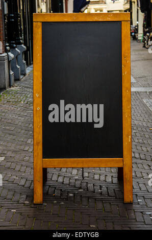 An empty chalkboard on a city street allows blank space for a creative message Stock Photo