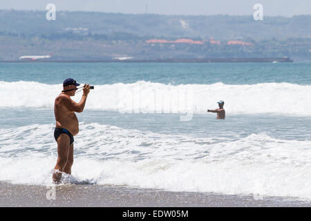 An amateur photographer taking photos on the beach Stock Photo