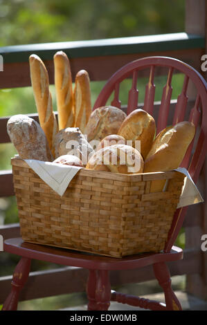 Assorted breads in basket on chair Stock Photo