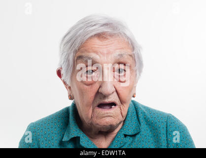 Elderly woman with surprised expression and isolated on white background Stock Photo