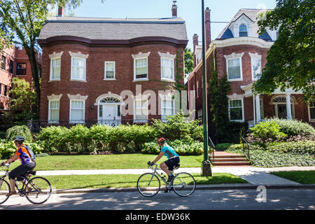 Chicago Illinois,South Side,South Woodlawn Avenue,houses,homes,mansions,woman female women,bikers,bicycles,biking,riding,IL140907024 Stock Photo