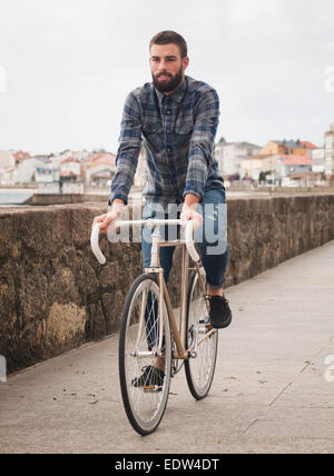 Hipster man riding in a fixie bike in the city. Stock Photo