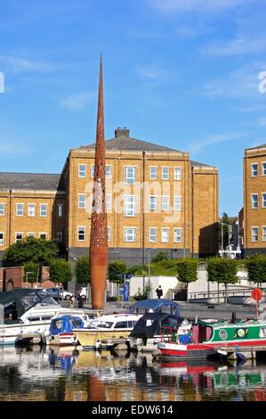 Boats moored in Gloucester Docks with a large metal sculpture to the rear, Gloucester, Gloucestershire, England, UK, Europe. Stock Photo