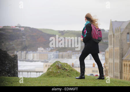 Aberystwyth, Wales, UK. 10th January, 2015. UK weather.  A woman battles against storm force winds in the Castle grounds in Aberystwyth. Credit:  Jon Freeman/Alamy Live News Stock Photo