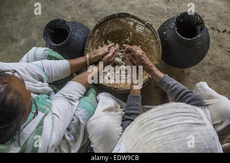 Dibrugarh, Assam, India. 10th Jan, 2015. Elderly Ahom tribal women prepares 'Saaj-Pani' (Rice Beer) using the indigenous method at her house ahead of Bhogali Bihu - The festival of feast, at a village in Dibrugarh district of northeastern Assam state on January 10, 2015. Rice beer is a delicacy among all the tribal communities inhabiting northeast India and almost each and every household prepares their own rice beer for their daily consumption. © Luit Chaliha/ZUMA Wire/ZUMAPRESS.com/Alamy Live News Stock Photo