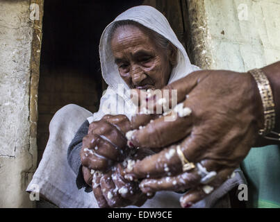 Dibrugarh, Assam, India. 10th Jan, 2015. An elderly Ahom tribal woman prepares 'Saaj-Pani' (Rice Beer) using the indigenous method at her house ahead of Bhogali Bihu - The festival of feast, at a village in Dibrugarh district of northeastern Assam state on January 10, 2015. Rice beer is a delicacy among all the tribal communities inhabiting northeast India and almost each and every household prepares their own rice beer for their daily consumption. © Luit Chaliha/ZUMA Wire/ZUMAPRESS.com/Alamy Live News Stock Photo