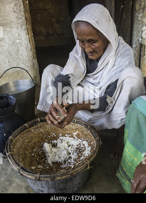 Dibrugarh, Assam, India. 10th Jan, 2015. An elderly Ahom tribal woman prepares 'Saaj-Pani' (Rice Beer) using the indigenous method at her house ahead of Bhogali Bihu - The festival of feast, at a village in Dibrugarh district of northeastern Assam state on January 10, 2015. Rice beer is a delicacy among all the tribal communities inhabiting northeast India and almost each and every household prepares their own rice beer for their daily consumption. © Luit Chaliha/ZUMA Wire/ZUMAPRESS.com/Alamy Live News Stock Photo