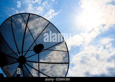 satellite dish and cloudy sky with sunbeam in afternoon (Silhouette style) Stock Photo