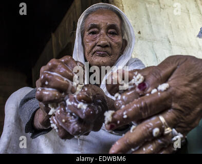 Dibrugarh, Assam, India. 10th Jan, 2015. An elderly Ahom tribal woman prepares 'Saaj-Pani' (rice beer) using the indigenous method at her house ahead of Bhogali Bihu (festival of feast) at a village in Dibrugarh district of northeastern Assam state. Rice beer is a delicacy among all the tribal communities inhabiting northeast India and almost each and every household prepares their own rice beer for their daily consumption. © Luit Chaliha/ZUMA Wire/ZUMAPRESS.com/Alamy Live News Stock Photo