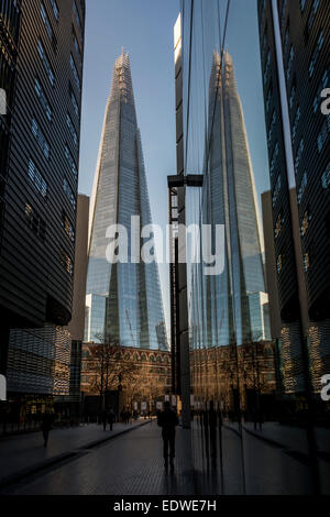 View down More London Place to the Shard which is reflected in the glass buildings of More London Stock Photo