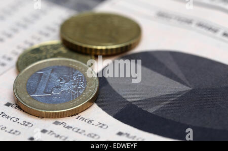 Currencies on financial graph on paper Stock Photo